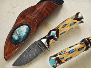 Damascus-pattern knife with brown wood handle and turquoise inlays, beside a brown leather sheath.
