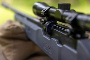 The Komplete NCR uses a 12-round rotary magazine that seats into the receiver beneath the scope, allowing quick follow-up shots with the side-lever action.