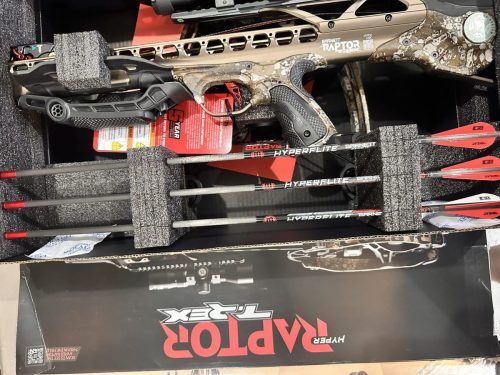 Camouflage Barnett HyperLite crossbow secured in foam-lined case with arrows visible nearby.